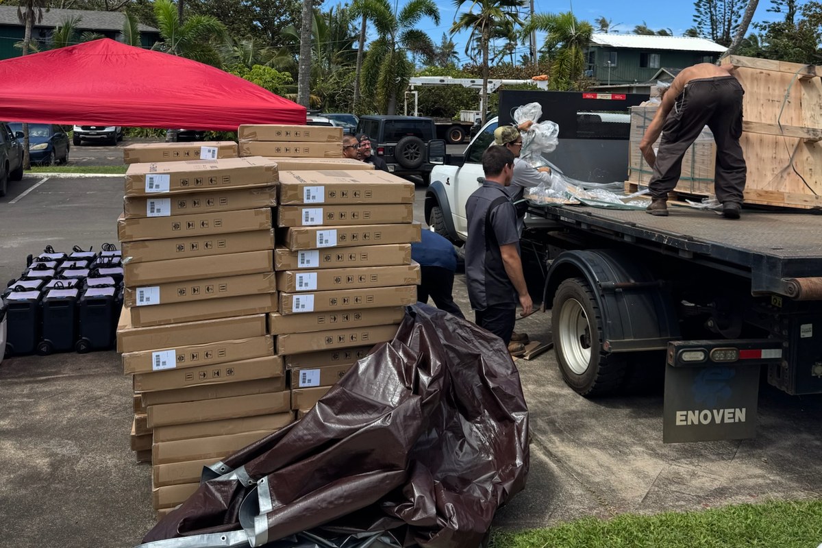 Pallets of solar panels and power stations being unloaded at the Wainiha distribution site